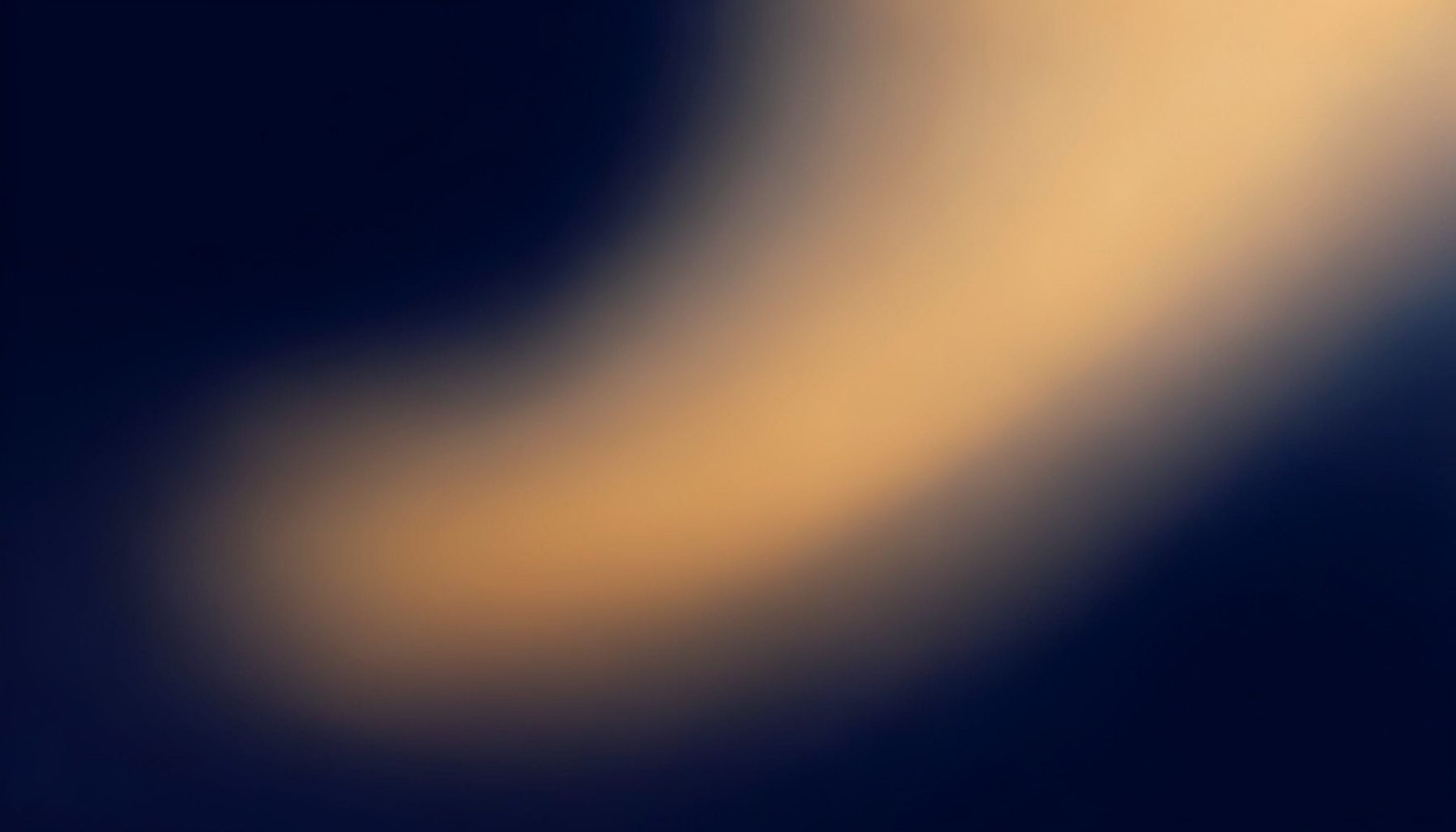 Warm abstract gradient blending deep navy and soft amber tones, suggesting connection and forward motion.