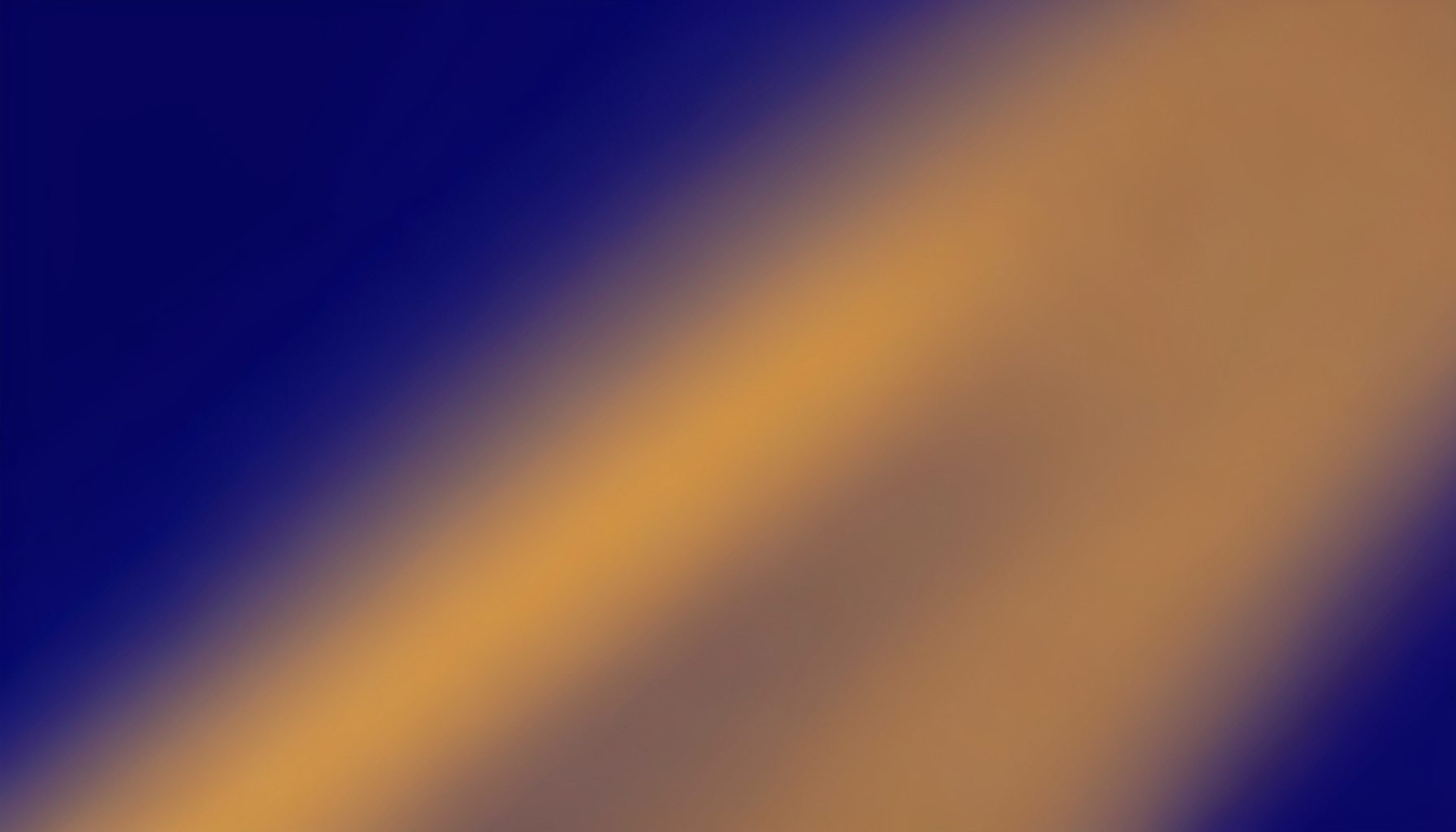 Abstract gradient composition with deep indigo and warm amber tones blending diagonally across the frame, no figures or objects