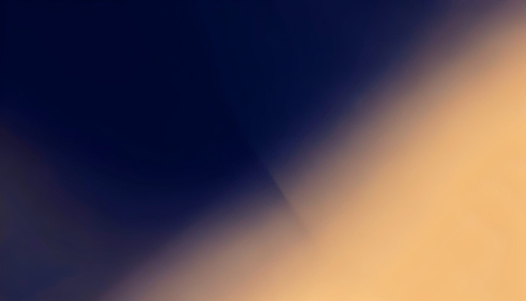 Warm abstract gradient blending deep navy and soft amber tones, suggesting connection and digital outreach